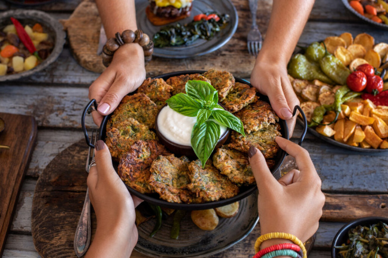 Many vegetable fritters in the plate with white sauce. Mücver or mucver.