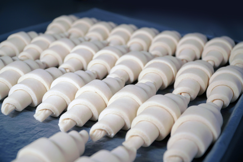 Cold frozen uncooked croissant dough just out of a freezer.