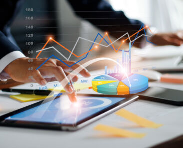Businessman using tablet and laptop analyzing sales data and economic growth graph chart. Business strategy. Digital marketing. Business innovation technology concept