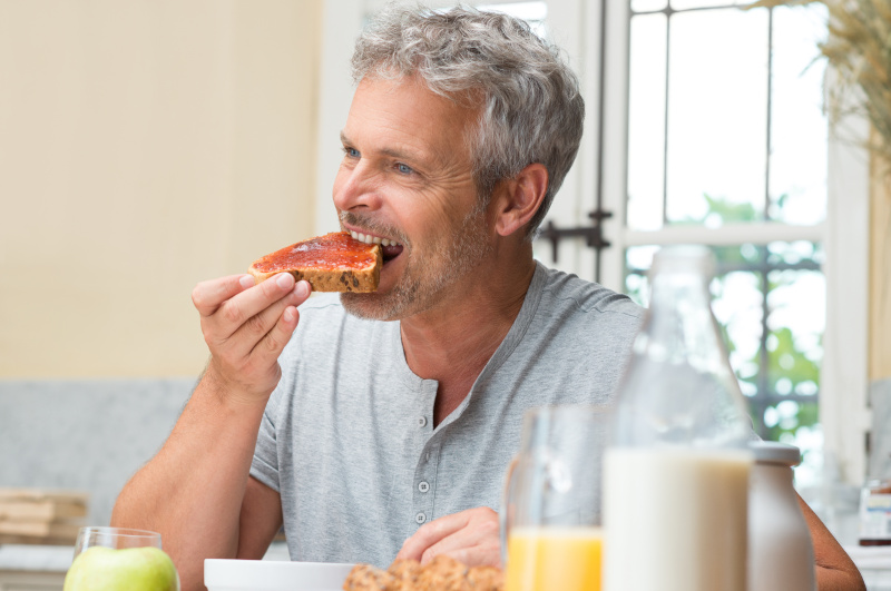 Man Eating A Jam Toast